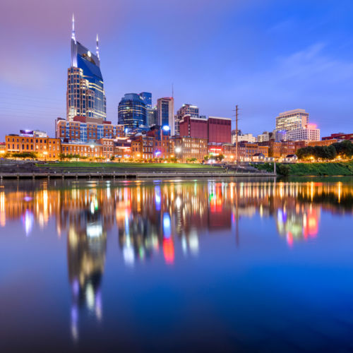 Nashville, Tennessee, USA skyline on the Cumberland River at night.